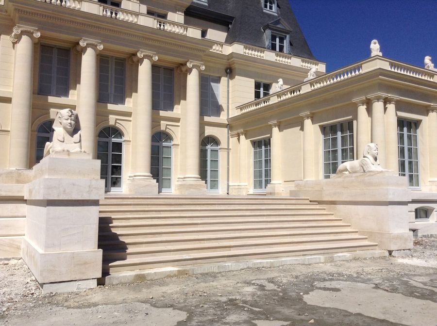 Perron d'un château en pierre de taille orné de sphinx sculptés, restauration Batipose
