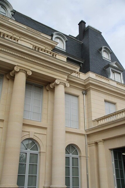 Château en pierre de taille restauré par Batipose, colonnes ioniques et toiture d'ardoise